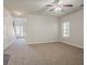 Open-concept living room with neutral walls, ceiling fan and a view into the entry hall at 2154 Dodson Woods Dr, Fairburn, GA 30213