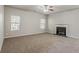Bright living room with carpet, fireplace, ceiling fan and natural light from the windows at 2154 Dodson Woods Dr, Fairburn, GA 30213