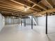 Unfinished basement featuring exposed wood ceiling, white painted walls, and stairs to upper level at 3564 Sage Dr, Lithia Springs, GA 30122