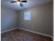 This bedroom features hardwood floors, a ceiling fan, neutral paint and a window at 3564 Sage Dr, Lithia Springs, GA 30122