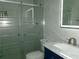 Bathroom with a white marble style sink, tile floor and updated shower with sliding glass door at 6051 Wintergreen Rd, Norcross, GA 30093