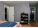 Neutral bedroom featuring a bathroom entry and built-in shelving unit, offering practical storage at 6051 Wintergreen Rd, Norcross, GA 30093