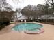 Community pool with attached spa, surrounded by a black metal fence at 6051 Wintergreen Rd, Norcross, GA 30093