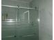 Updated shower featuring glass door with frosted accents and built in shelf at 6051 Wintergreen Rd, Norcross, GA 30093