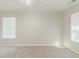 Bright and airy bedroom with neutral walls and carpeting and two windows at 811 Lake Chase, Fairburn, GA 30213
