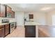 Kitchen featuring stainless steel appliances, granite countertops, and dark wood cabinets at 811 Lake Chase, Fairburn, GA 30213