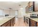 Modern kitchen with stainless steel appliances, granite countertops, and dark wood cabinets at 811 Lake Chase, Fairburn, GA 30213