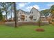 Backyard featuring lush green grass, privacy fence, and modern white siding at 826 Gaston Street Sw, Atlanta, GA 30310