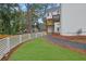 A lush green backyard with a white picket fence, offering privacy and charm at 826 Gaston Street Sw, Atlanta, GA 30310