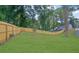 Lush green backyard with a beautiful lawn and wood privacy fence at 826 Gaston Street Sw, Atlanta, GA 30310