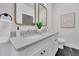 Modern bath featuring double sink vanity with white cabinetry, marble counters and stylish fixtures at 826 Gaston Street Sw, Atlanta, GA 30310