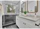 Bathroom with double sink vanity, marble counters and floors, black fixtures and walk-in shower at 826 Gaston Street Sw, Atlanta, GA 30310