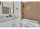 Updated bath features shower-over-tub, light wood-style tile, and a white vanity at 826 Gaston Street Sw, Atlanta, GA 30310