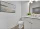 Bathroom featuring a white sink, toilet, mirror and elegant decor at 826 Gaston Street Sw, Atlanta, GA 30310