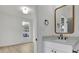 Bathroom featuring white vanity with marble counters, black fixtures and adjacent bedroom at 826 Gaston Street Sw, Atlanta, GA 30310