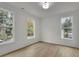 Bright bedroom features wood floors and three windows at 826 Gaston Street Sw, Atlanta, GA 30310