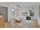 Bright bedroom features wood floors, panelled wall detail, neutral rug, ceiling fan and two windows at 826 Gaston Street Sw, Atlanta, GA 30310