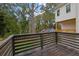 Wooden deck with dark railing offering views of the tree-lined backyard, perfect for outdoor living at 826 Gaston Street Sw, Atlanta, GA 30310