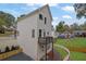 Charming home exterior with white siding, a small upper deck, and manicured landscaping at 826 Gaston Street Sw, Atlanta, GA 30310