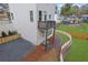 Home exterior with backyard view, small upper deck, and manicured landscaping with a white fence at 826 Gaston Street Sw, Atlanta, GA 30310