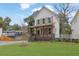 Charming two-story home with a landscaped yard, covered porch, and a paved driveway at 826 Gaston Street Sw, Atlanta, GA 30310