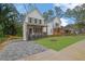 View of the charming two-story home with a landscaped yard and a paved driveway at 826 Gaston Street Sw, Atlanta, GA 30310