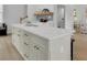 Bright kitchen island boasts white cabinets, modern hardware, and a sleek countertop, offering ample storage at 826 Gaston Street Sw, Atlanta, GA 30310