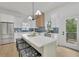 Spacious open kitchen with an island, stainless steel appliances, and access to an outdoor deck at 826 Gaston Street Sw, Atlanta, GA 30310