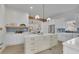Modern open-concept kitchen boasts a central island, white cabinets, and stainless steel appliances at 826 Gaston Street Sw, Atlanta, GA 30310