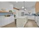 Modern kitchen features white cabinets, blue tile backsplash, stainless steel appliances, and a central island at 826 Gaston Street Sw, Atlanta, GA 30310