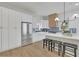 Well-lit kitchen with white cabinetry, stainless steel appliances, and a center island with bar stool seating at 826 Gaston Street Sw, Atlanta, GA 30310
