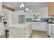 Bright kitchen showcases white cabinets, an island, stainless appliances, and farm sink, perfect for cooking at 826 Gaston Street Sw, Atlanta, GA 30310