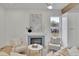Cozy living room with a fireplace and tile surround, comfortable seating, and natural light from a window at 826 Gaston Street Sw, Atlanta, GA 30310
