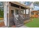 View of covered porch with stained wood columns, and horizontal railing at 826 Gaston Street Sw, Atlanta, GA 30310