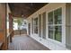 Covered porch with ceiling fan, stained wood columns, and dark wood plank floor at 826 Gaston Street Sw, Atlanta, GA 30310