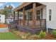 Covered porch with stained wood columns, horizontal railing, and landscaping at 826 Gaston Street Sw, Atlanta, GA 30310