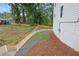 Exterior view of a home with a side yard, featuring a white fence and walkway at 826 Gaston Street Sw, Atlanta, GA 30310