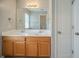 Bathroom featuring double sinks and a vanity with wood cabinets, plus a large mirror and a linen closet at 104 Shadow Creek Ct, Fairburn, GA 30213