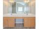 Bright bathroom featuring double sinks, a large mirror, and neutral tiling at 104 Shadow Creek Ct, Fairburn, GA 30213