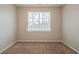 Cozy bedroom featuring neutral carpet and a bright window view at 104 Shadow Creek Ct, Fairburn, GA 30213