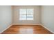 Bedroom with hardwood floors and a window overlooking a green space at 104 Shadow Creek Ct, Fairburn, GA 30213