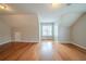 Bright bedroom with hardwood floors and natural light from the window at 104 Shadow Creek Ct, Fairburn, GA 30213