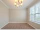 Inviting dining room with modern chandelier fixture and natural light at 104 Shadow Creek Ct, Fairburn, GA 30213
