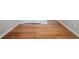 Hallway featuring hardwood floors and white baseboards at 104 Shadow Creek Ct, Fairburn, GA 30213