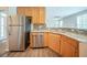 Bright kitchen featuring wood cabinets, granite countertops, and stainless steel appliances at 104 Shadow Creek Ct, Fairburn, GA 30213