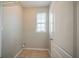 Functional laundry room equipped with tile flooring and window at 104 Shadow Creek Ct, Fairburn, GA 30213