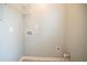 Neat laundry room with overhead shelving and convenient utility connections at 104 Shadow Creek Ct, Fairburn, GA 30213