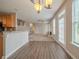 Open living space with hard flooring, kitchen bar, and natural light at 104 Shadow Creek Ct, Fairburn, GA 30213