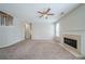 Inviting living room featuring a fireplace, neutral walls, and staircase access at 104 Shadow Creek Ct, Fairburn, GA 30213