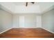 Comfortable main bedroom with hardwood floors, neutral walls, and a ceiling fan at 104 Shadow Creek Ct, Fairburn, GA 30213